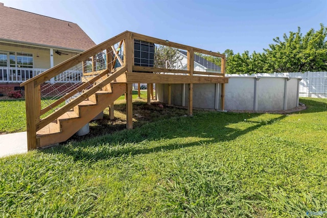 1045 Cove Rd, Southside, AL 35907 - rear view of property featuring an outdoor pool, a wooden deck, a lawn, and stairs