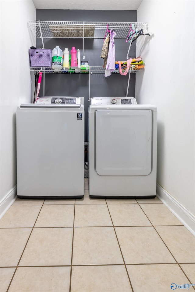 1045 Cove Rd, Southside, AL 35907 - clothes washing area featuring laundry area, tile patterned floors, baseboards, and washer and clothes dryer