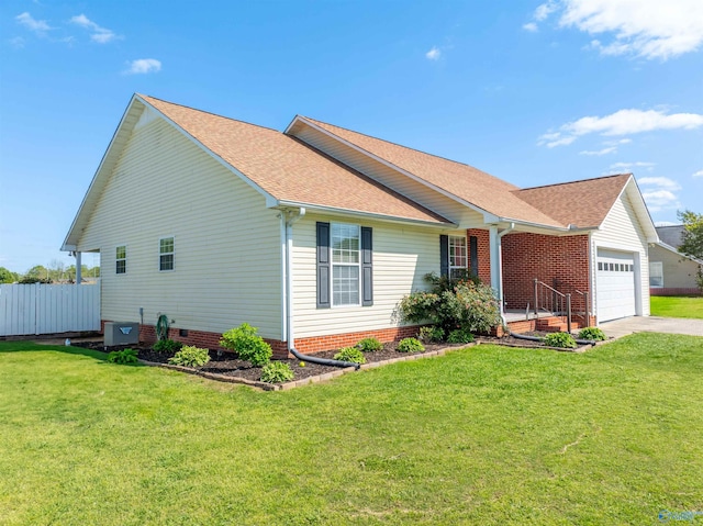 1045 Cove Rd, Southside, AL 35907 - view of property exterior featuring a garage, central air condition unit, a yard, a shingled roof, and concrete driveway