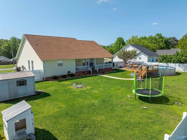 1045 Cove Rd, Southside, AL 35907 - rear view of house featuring a storage shed, a trampoline, a fenced backyard, an outdoor structure, and a fenced in pool