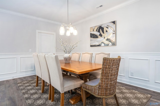 dining room with ornamental molding, dark wood-type flooring, and a notable chandelier