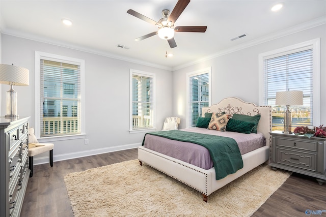 bedroom featuring ceiling fan, ornamental molding, and dark hardwood / wood-style flooring