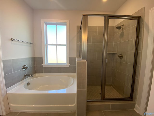 bathroom featuring tile patterned flooring and plus walk in shower