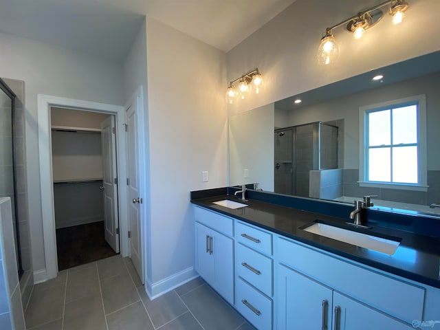 bathroom with vanity, an enclosed shower, and tile patterned flooring