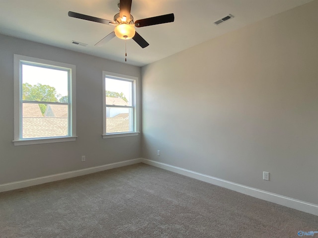 empty room featuring carpet floors and ceiling fan