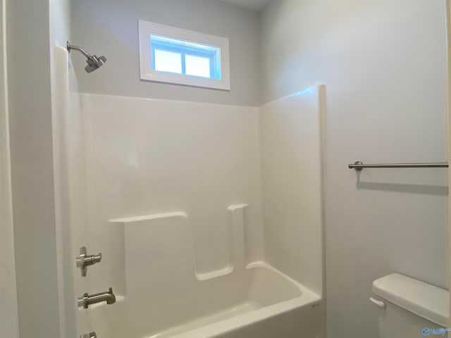 bathroom featuring shower / bath combination and toilet