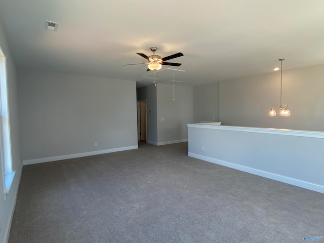 unfurnished room featuring ceiling fan and carpet