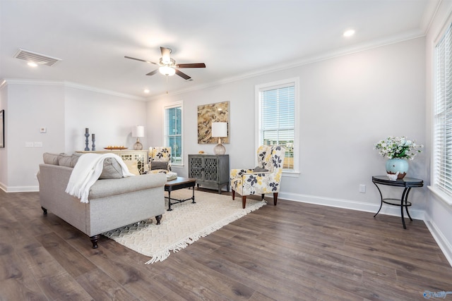 living room featuring crown molding, a healthy amount of sunlight, and dark hardwood / wood-style floors