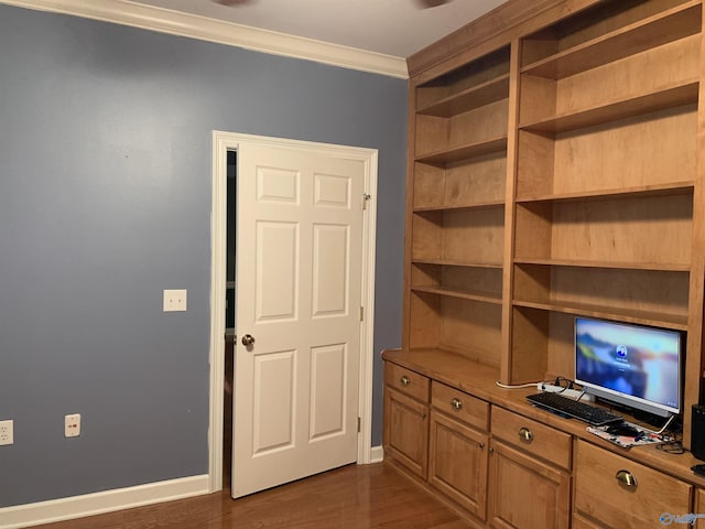 unfurnished office featuring crown molding and dark wood-type flooring