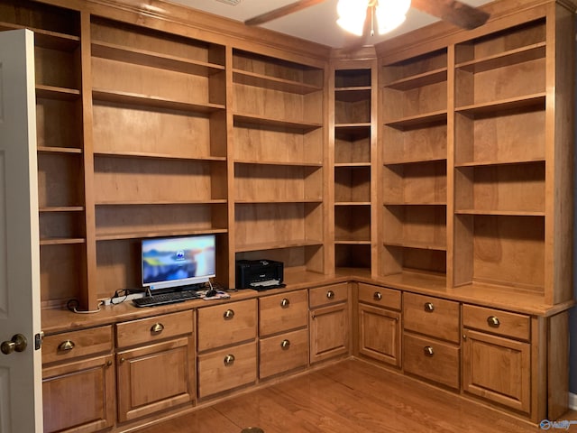 walk in closet with hardwood / wood-style flooring