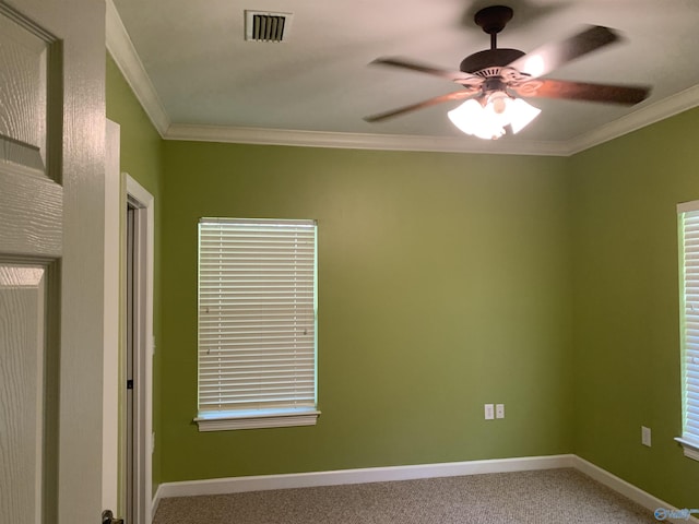 carpeted empty room with ceiling fan and ornamental molding