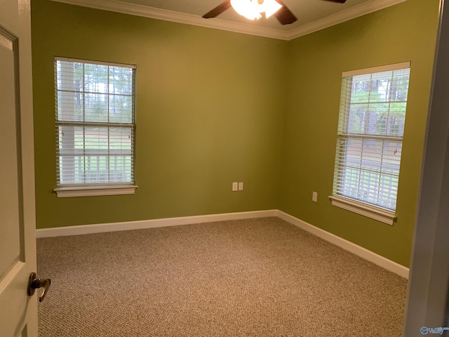 empty room featuring carpet, crown molding, and ceiling fan