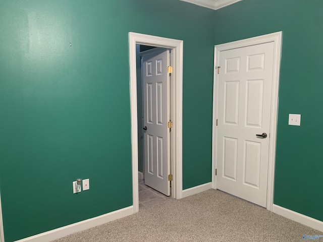 interior space featuring crown molding and light colored carpet