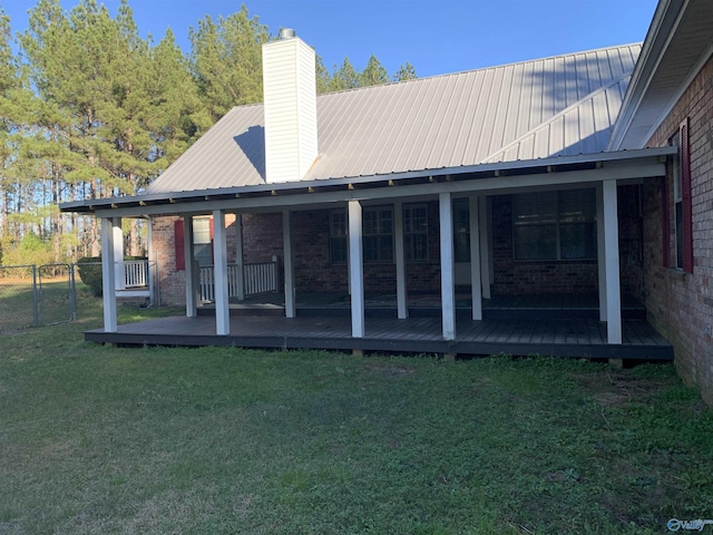 back of house featuring a yard