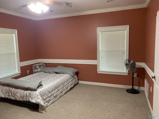 bedroom featuring carpet floors, ceiling fan, and crown molding