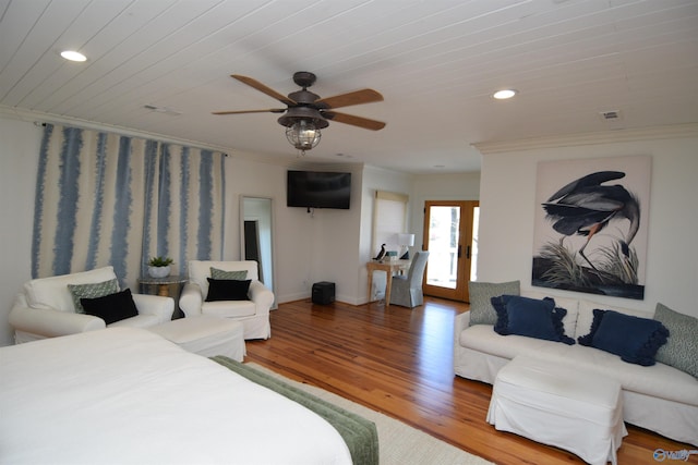 bedroom featuring hardwood / wood-style flooring, ornamental molding, ceiling fan, and french doors