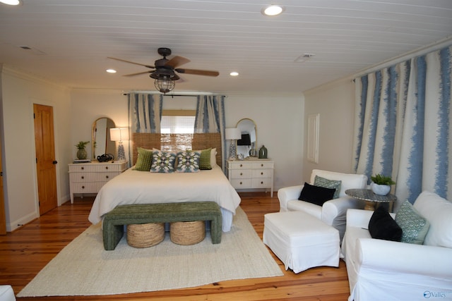 bedroom featuring crown molding, ceiling fan, and hardwood / wood-style floors