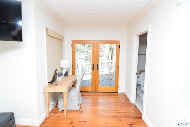 entryway featuring crown molding, light hardwood / wood-style flooring, and french doors