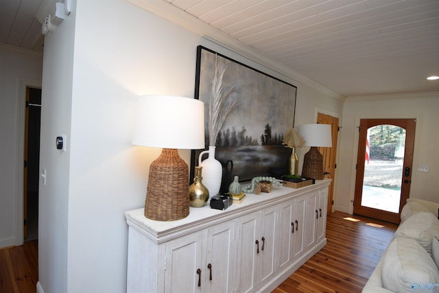 hallway with dark wood-type flooring and crown molding