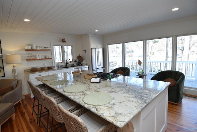 dining space with dark hardwood / wood-style flooring, sink, and ornamental molding