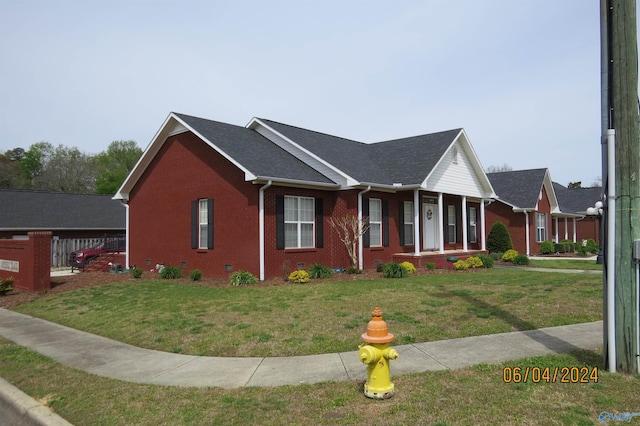 view of front of property with a porch and a front yard