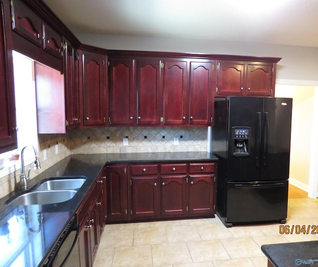 kitchen featuring tasteful backsplash, sink, and black fridge with ice dispenser