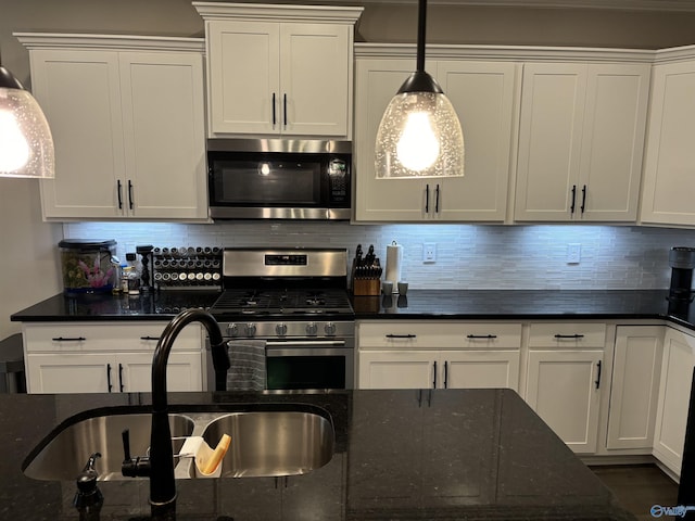12794 Hudbug Dr, Madison, AL 35756 - kitchen featuring appliances with stainless steel finishes, a sink, dark stone counters, tasteful backsplash, and white cabinets