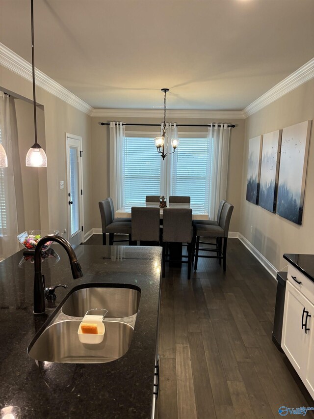 12794 Hudbug Dr, Madison, AL 35756 - dining space featuring crown molding, baseboards, and dark wood finished floors