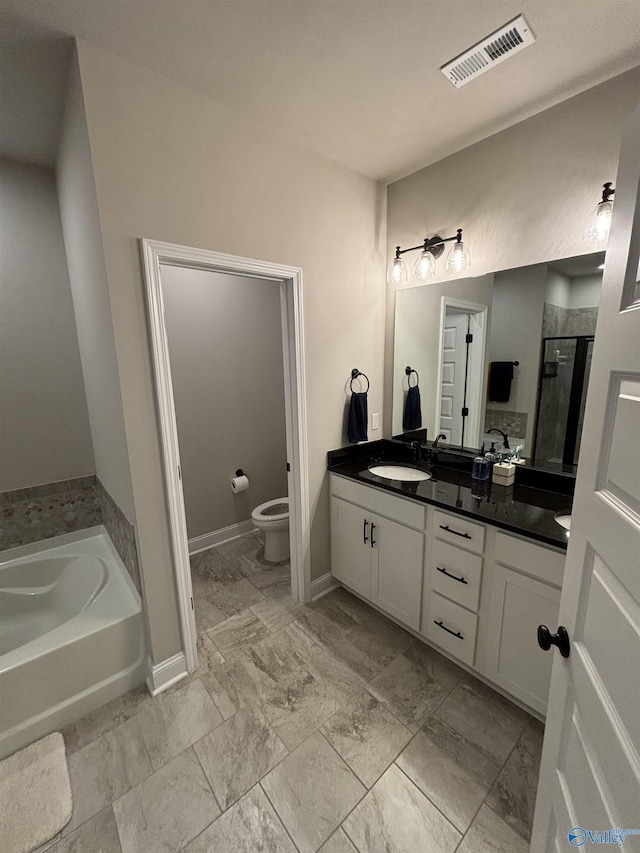 12794 Hudbug Dr, Madison, AL 35756 - full bath featuring double vanity, toilet, a shower stall, a garden tub, and baseboards