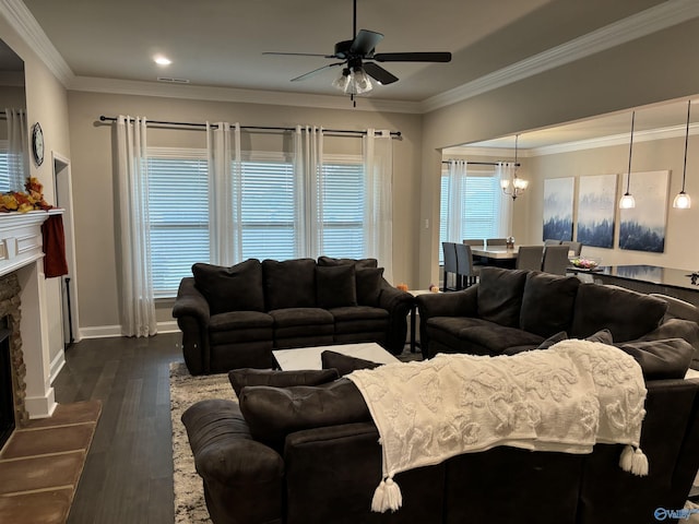 12794 Hudbug Dr, Madison, AL 35756 - living area with a chandelier, ceiling fan, a stone fireplace, ornamental molding, and dark wood-style flooring
