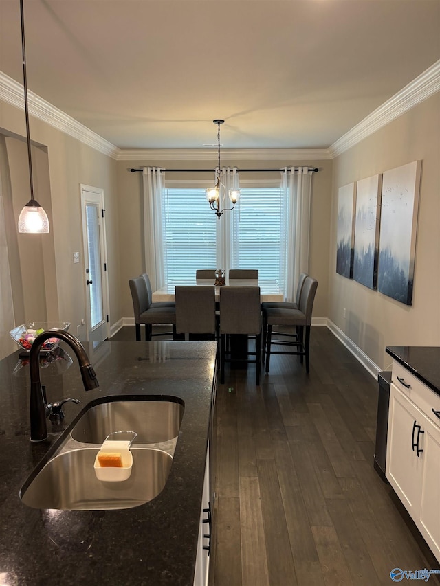 12794 Hudbug Dr, Madison, AL 35756 - dining area featuring crown molding, dark wood finished floors, baseboards, and a chandelier