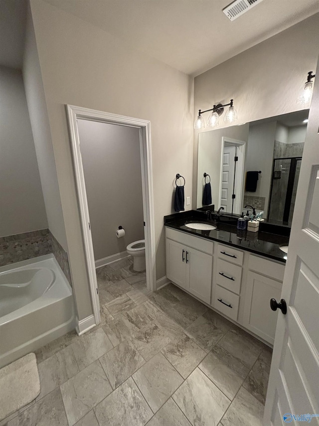 12794 Hudbug Dr, Madison, AL 35756 - bathroom with vanity, a stall shower, a garden tub, toilet, and baseboards