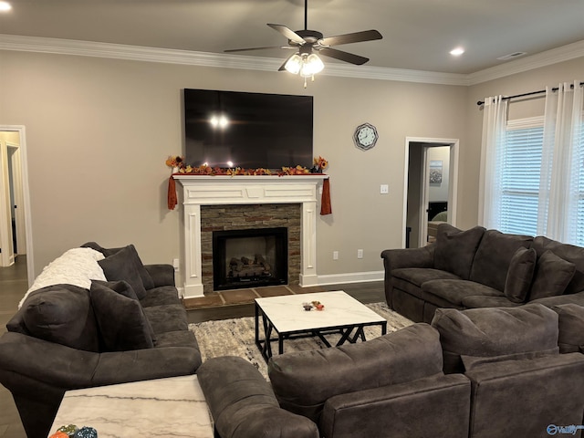 12794 Hudbug Dr, Madison, AL 35756 - living area featuring dark wood-style floors, ornamental molding, ceiling fan, a stone fireplace, and baseboards