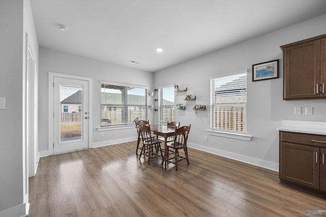 dining room with visible vents, baseboards, wood finished floors, and recessed lighting