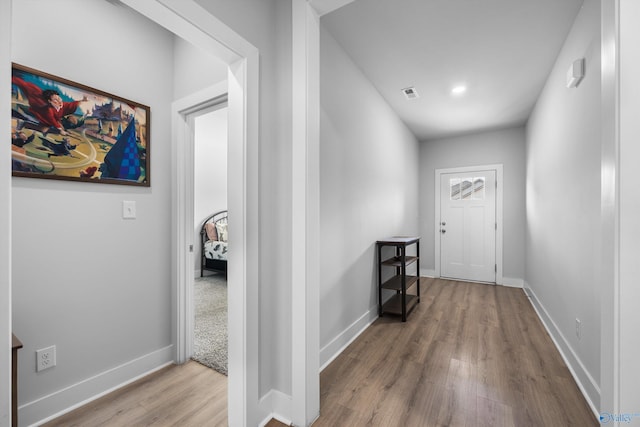 interior space featuring baseboards, visible vents, and wood finished floors