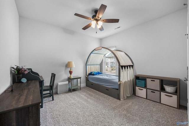 carpeted bedroom with a ceiling fan and visible vents