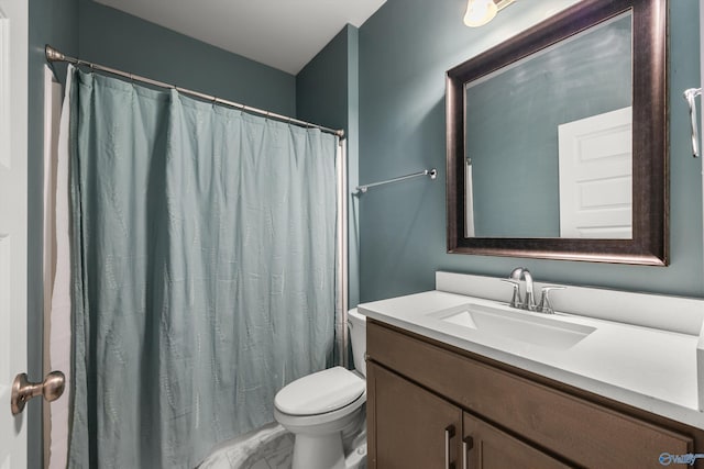 bathroom featuring toilet, marble finish floor, a shower with curtain, and vanity