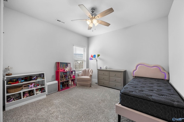 carpeted bedroom with visible vents and a ceiling fan