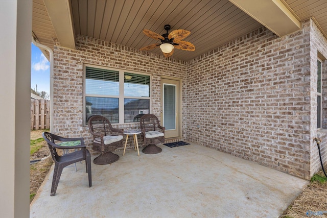 view of patio with fence and a ceiling fan