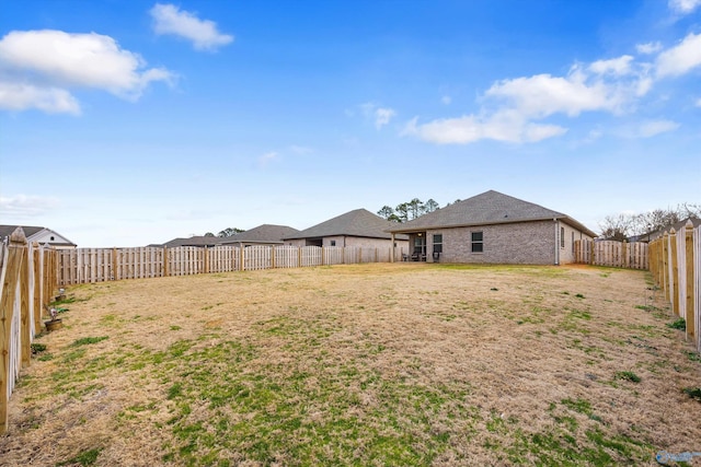 view of yard with a fenced backyard