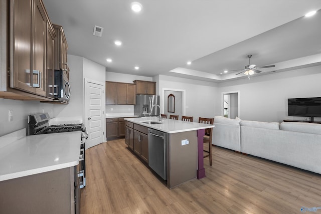 kitchen featuring appliances with stainless steel finishes, open floor plan, visible vents, and light wood-style flooring