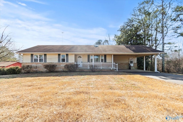 single story home featuring a front yard, a carport, and covered porch