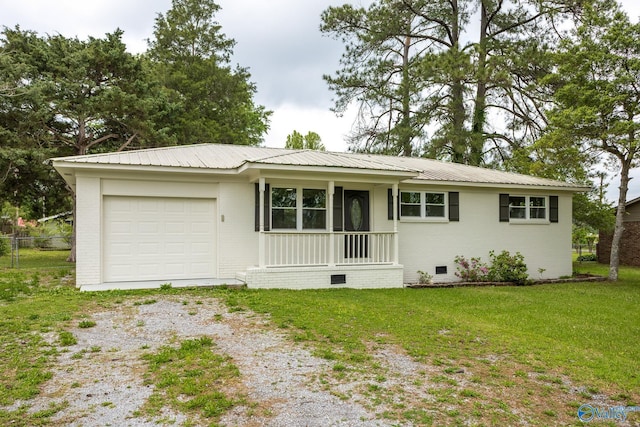 ranch-style house featuring a front lawn, crawl space, a garage, metal roof, and driveway