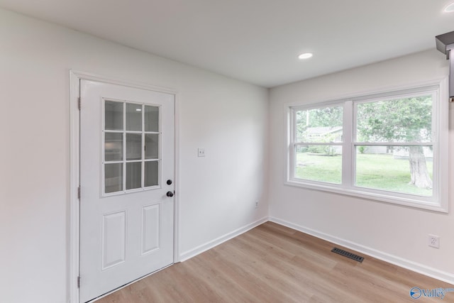 entryway featuring baseboards, visible vents, light wood finished floors, and recessed lighting