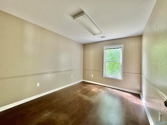 spare room featuring hardwood / wood-style flooring