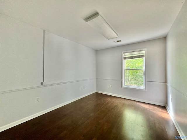 unfurnished room featuring dark hardwood / wood-style floors