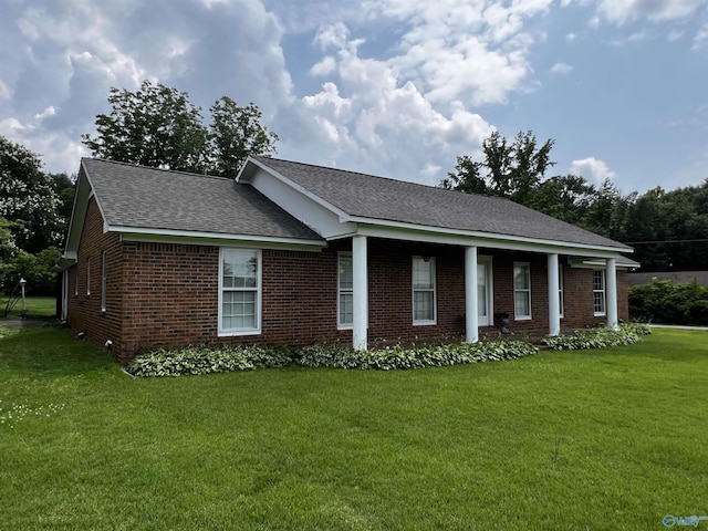 16052 Court St, Moulton, AL 35650 - view of front facade with a front lawn, brick siding, and roof with shingles