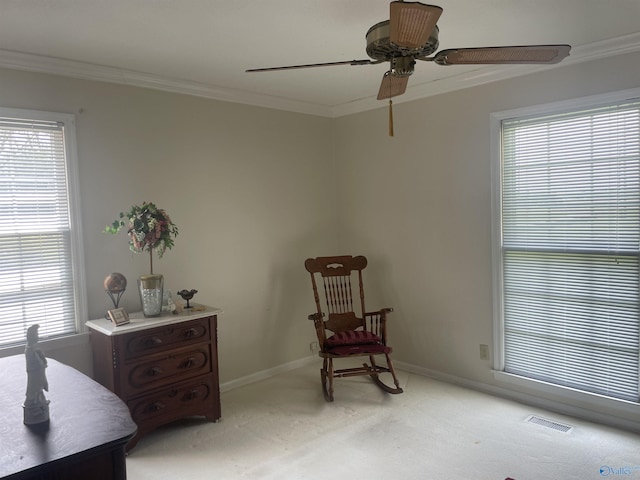 16052 Court St, Moulton, AL 35650 - sitting room with light colored carpet, ornamental molding, ceiling fan, baseboards, and plenty of natural light