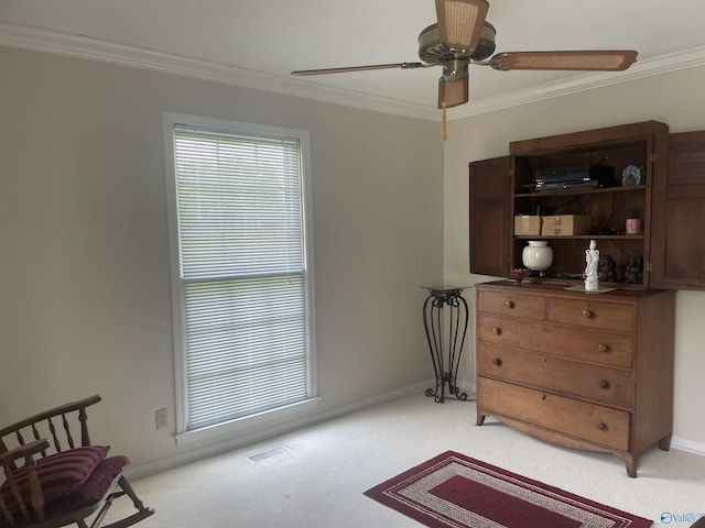 16052 Court St, Moulton, AL 35650 - sitting room featuring light colored carpet, crown molding, ceiling fan, and baseboards