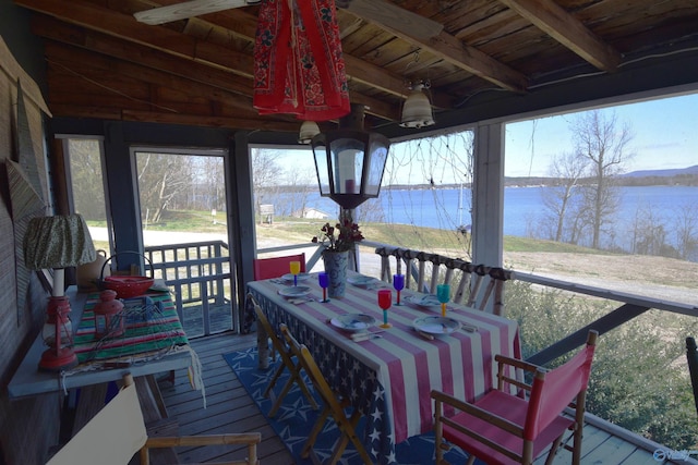 sunroom featuring a wealth of natural light, beamed ceiling, wood ceiling, and a water view